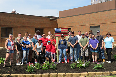 FA members pose with administrators and students at the Garden Project