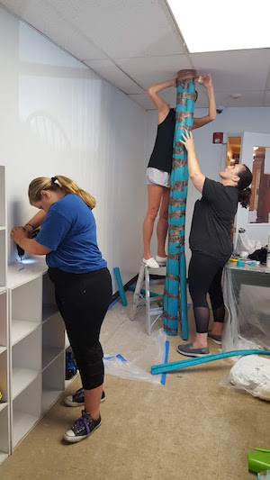 Interior design students building and painting