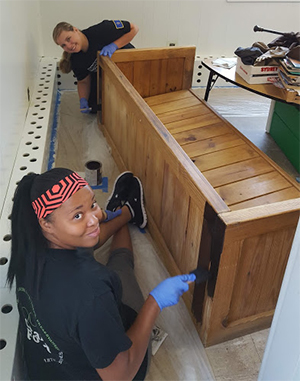 Interior design students working on a bench