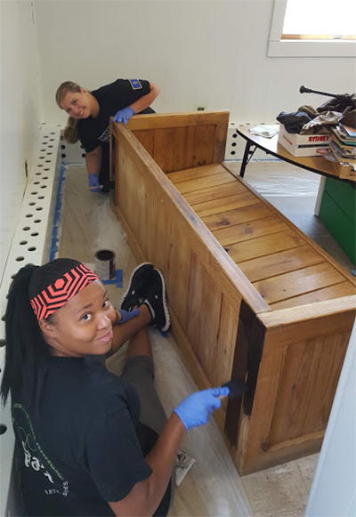 Interior design students working on a bench for a class project