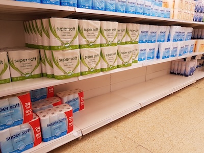 image of empty shelf where toilet tissue should be during Covid pandemic