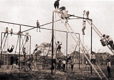 historical tall metal jungle gym with children climbing on it