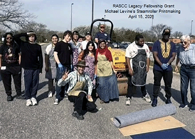 Michael Levine posing with ART181 students in front of a steamroller