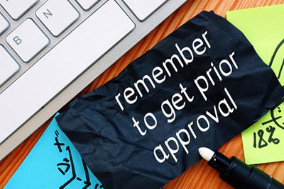 Desk with keyboard and scrap of paper that says 