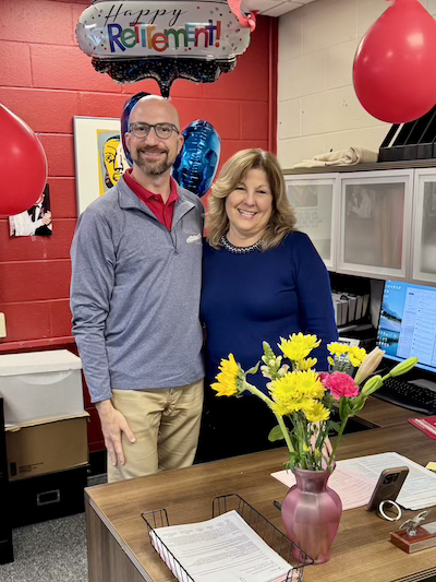 Dante Morelli and Anita Greifenstein posing at Anita's desk